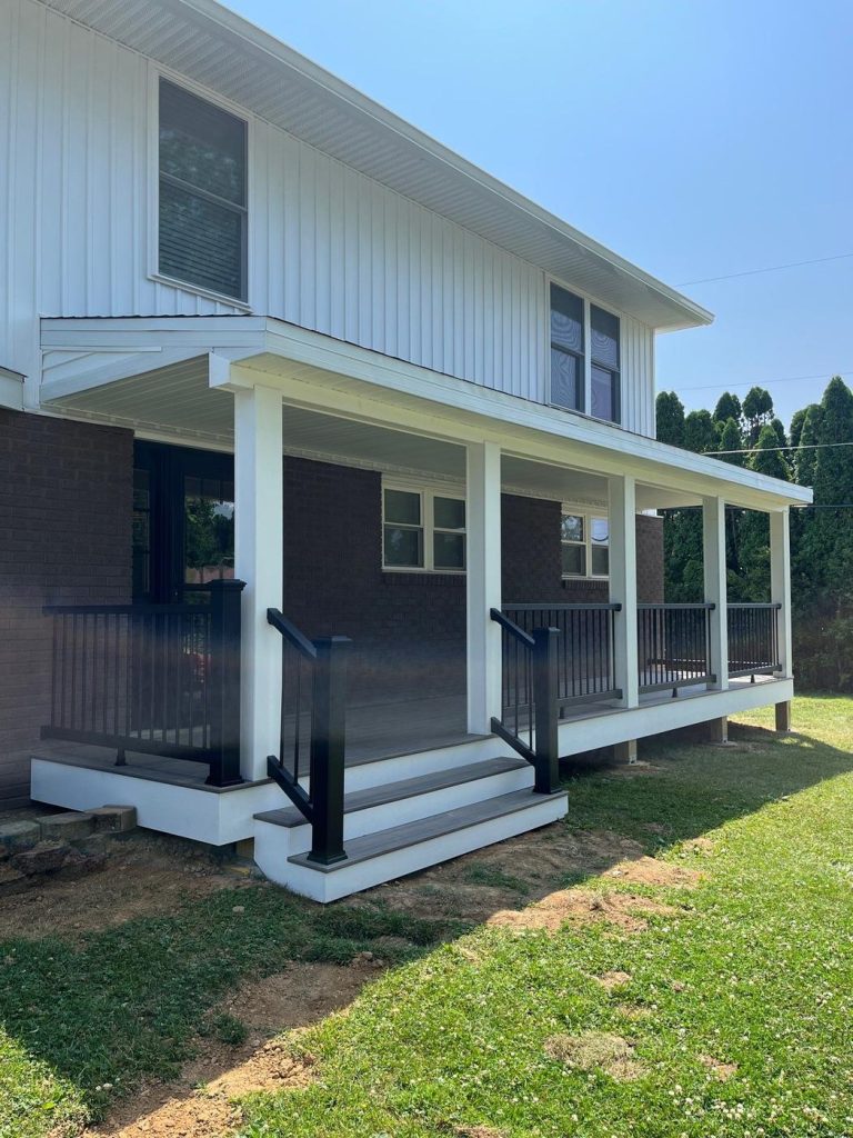 Covered front porch with white columns and black railing built by Cedar Creek Construction in the Lehigh Valley, PA