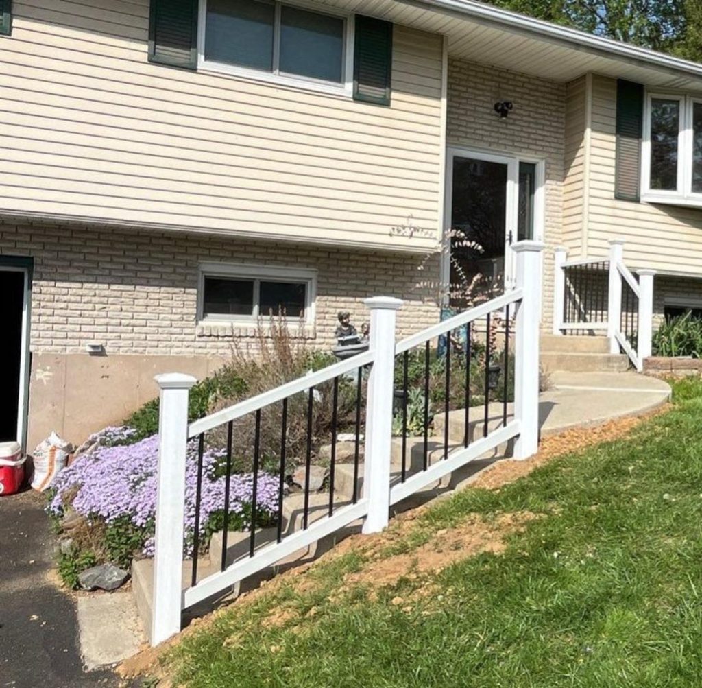 White deck railing with black metal balusters installed by Cedar Creek Construction in the Lehigh Valley, PA